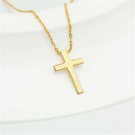 A Symbolic Addition: The Significance of a Gilded Link Adorned with a Crucifix